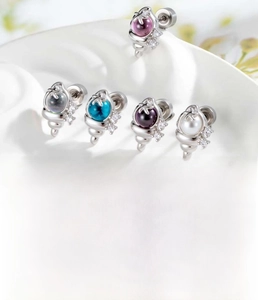 Detail view of 0.8x6mm titanium steel ear studs featuring colorful cubic zirconia stones