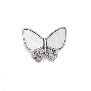 Detail view of butterfly brooch with iridescent mother of pearl and crystal inlay