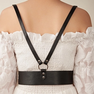 Punk style black leather harness belt with metal rings shown on a white dress
