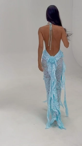 Detail of light blue lace maxi dress featuring backless halter neck and floral waist accents