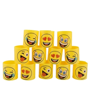 Set of 12 yellow rainbow spring toys with emoji faces stacked on a white background