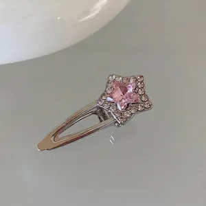 Macro detail of silver star hair clip with pink rhinestone and pavé crystal setting