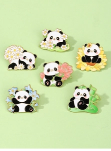 Macro detail of six panda enamel pins with floral elements on a light green surface