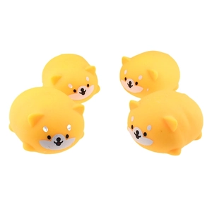 Close-up of four soft yellow Shiba Inu squishy stress relief toys on white background