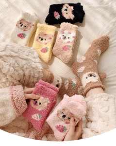 Detailed view of colorful coral fleece socks featuring cute bear and strawberry patterns