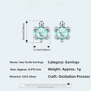 Close-up of S925 sterling silver sea turtle stud earrings with green center stone details