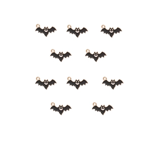 Detailed view of ten black metal bat pendants with gold loops for DIY jewelry making