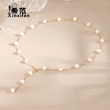 Close-up of pearl necklace with gold chain and elegant Y-shaped tassel structure