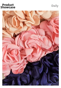 Detailed close-up of decorative satin rose fabric flowers in white pink and navy blue