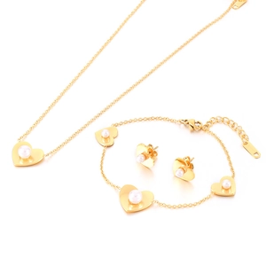 Golden heart jewelry set with pearls featuring necklace, bracelet and stud earrings