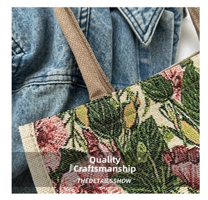 Macro shot of vintage floral jacquard fabric and reinforced canvas handles on a tote bag