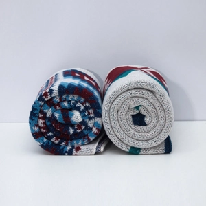 Macro view of multi-color geometric knit patterns on premium ethnic travel shawls