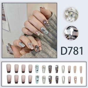 Press-on nail set featuring 3D planet charms, gothic crosses and zebra patterns