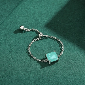 Adjustable S925 sterling silver chain ring with square green turquoise on a dark background
