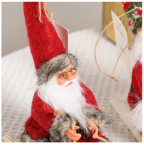 Close-up of Santa Claus ornament with red felt hat, white beard, and golden glasses