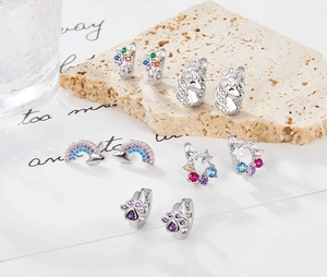 Detailed view of S925 silver earrings with colorful zircons on a natural stone base