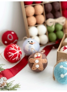 Detailed view of handmade wool felt Christmas balls with embroidered holiday patterns