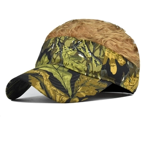 Detailed view of camouflage baseball visor with attached brown curly wig hair decoration
