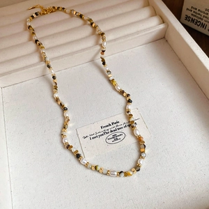Detail of freshwater pearl and agate beaded necklace with gold metal lobster clasp