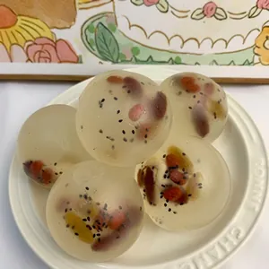 Detailed macro view of five translucent sensory stress balls with red bean and sesame filling