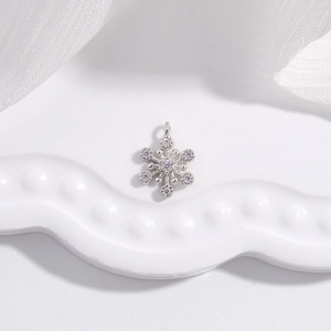 S925 sterling silver snowflake pendant with zircon crystals on a white wave tray
