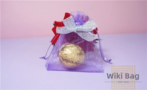 Purple organza gift bag with silver glitter bow detail for jewelry and chocolate