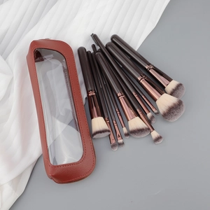 Set of 13 professional makeup brushes with rose gold ferrules and a red leather storage bag
