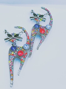 Close-up of vintage cat brooches featuring colorful rhinestones and intricate metalwork