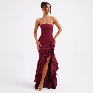 Detail of burgundy strapless dress featuring ruffled hemline and high slit design