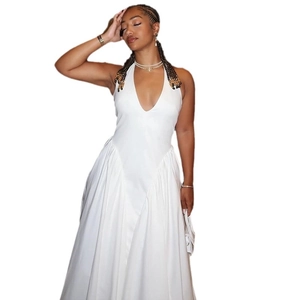 Elegant white halter neck maxi dress with deep V-neck and a flowing silhouette for women