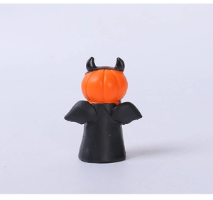 Detailed view of mini pumpkin devil figurine with orange head and black wings for Halloween