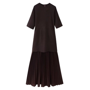 Detail of dark brown short sleeve dress featuring a slim knit bodice and pleated skirt