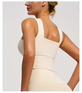 Detail of wide straps and back design on a beige high-impact sports bra