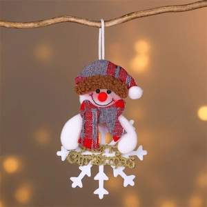Close-up of plush snowman ornament with Merry Christmas greeting on a snowflake base