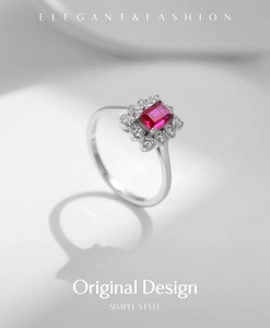 Macro view of a square red ruby ring with halo diamonds on a silver band