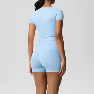 Rear view of light blue athletic yoga set featuring slim fit T-shirt and high waist shorts