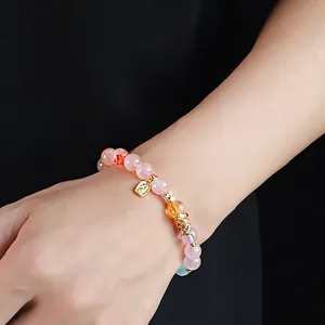 Pink and purple crystal beaded bracelet with a golden snake charm for women