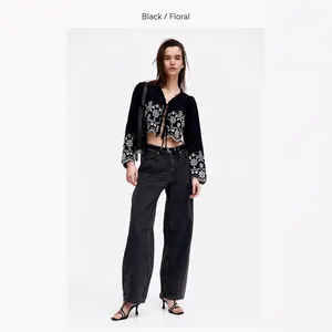 Retro black long sleeve shirt with white floral embroidery and ruffled tie collar
