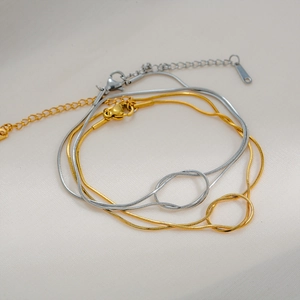 Versatile titanium steel snake chain bracelets with knot charm in gold and silver finishes