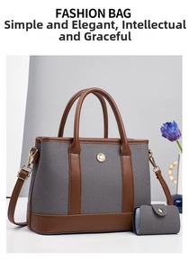 Detailed view of the grey canvas tote set with brown leather trim and golden flower buckle