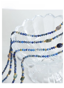 Detailed view of handmade beaded necklace with blue lapis lazuli and gold spacer beads