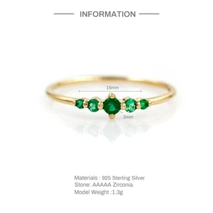 Detail of 925 sterling silver ring featuring five emerald green cubic zirconia stones