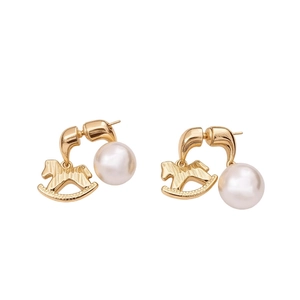 Elegant gold rocking horse earrings with large round pearls and brushed metal finish