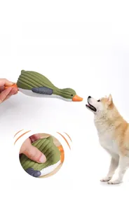 Detail of squeezing a latex squeaky duck toy for dogs showing its elastic texture