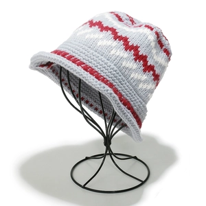 Macro detail of tricolor Fair Isle knit pattern on a wool blend bucket hat texture