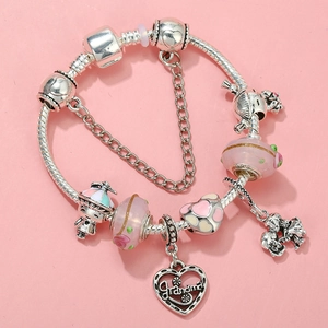 Detail of silver DIY charm bracelet with pink beads and Grandma engraved heart charm