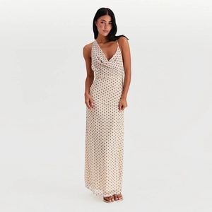 Detailed view of the cowl neck design on this French-style polka dot maxi dress