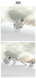 Detailed view of silver snowflake stud earring with zircon inlay and screw-back closure
