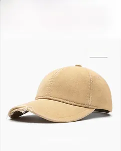 Detailed macro view of khaki cotton baseball cap showing distressed torn edges and textures
