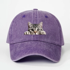 Detailed texture of purple washed denim fabric and funny cat print on baseball cap